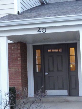 Front view of a house entrance with a dark door and number 48 above.
