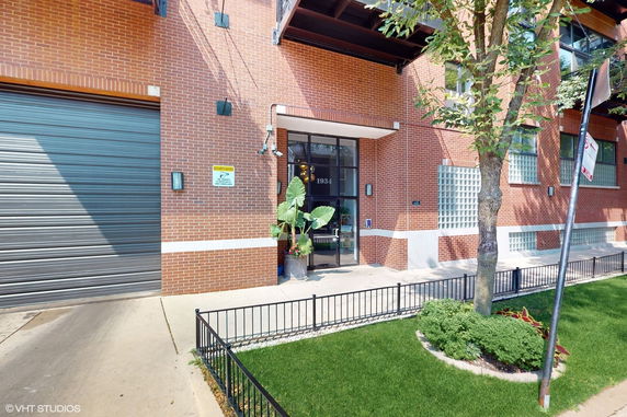 Front view of a brick building entrance with glass door