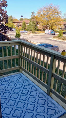 View from a wooden deck overlooking a residential street and other houses.