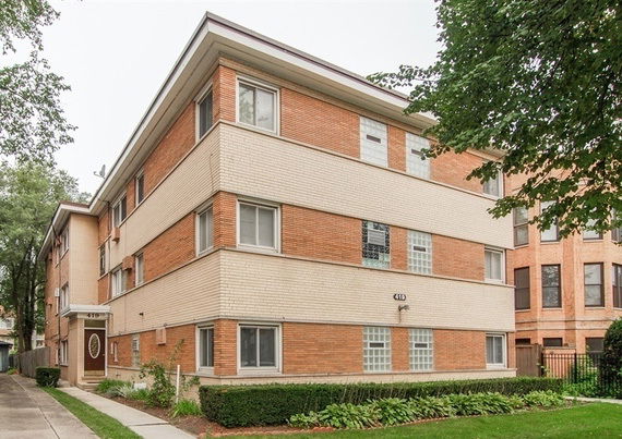 Front view of a three-story brick apartment building.