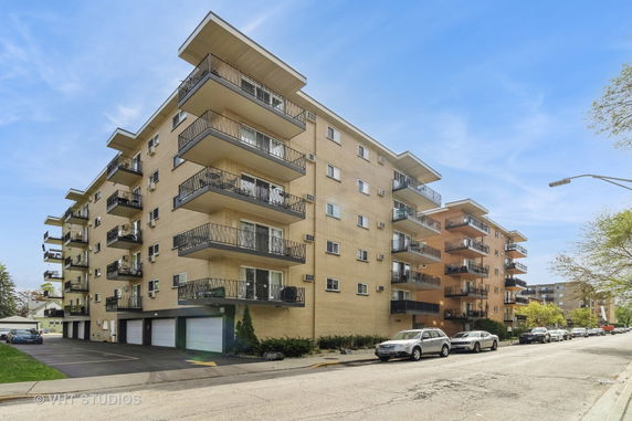 Front view of a multi-story building with multiple balconies.