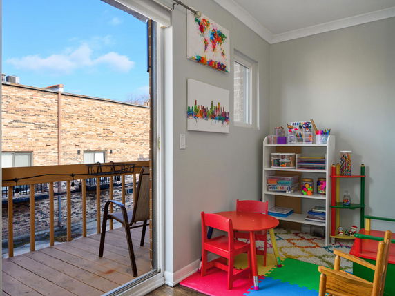 Indoor play area with colorful furniture and art supplies.