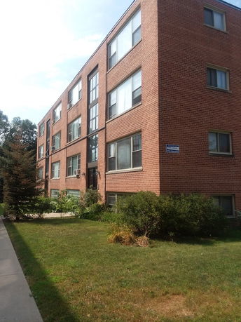 Front view of a multi-story brick building.