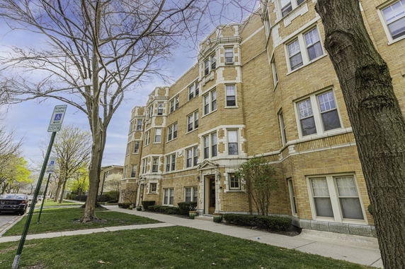 Front view of a multi-story brick apartment building.