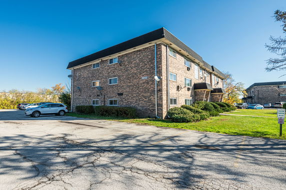 Front view of a three-story brick apartment building.