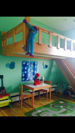 Indoor play area with loft bed and small table set.