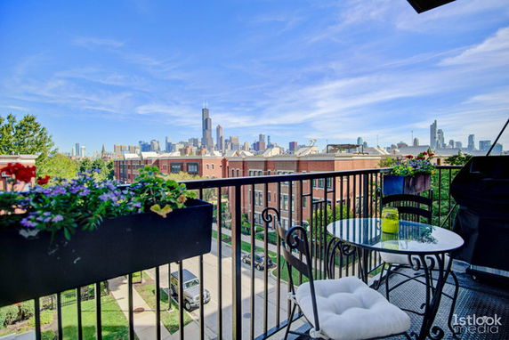 Panoramic view of city skyline from a balcony.