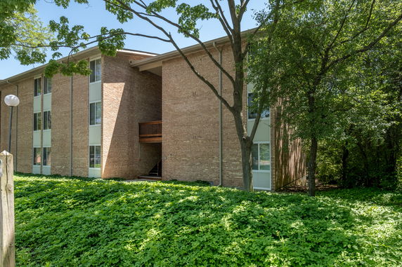 Front view of a multi-story brick apartment building.