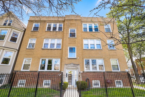 Front view of a three-story brick apartment building.