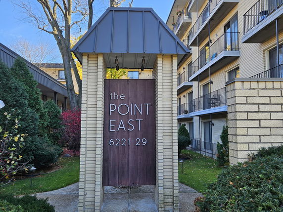 Front view of a multi-story building with balconies and a sign reading 'The Point East 6221 29'.