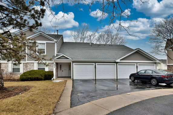 Front view of a two-story house with three garages.