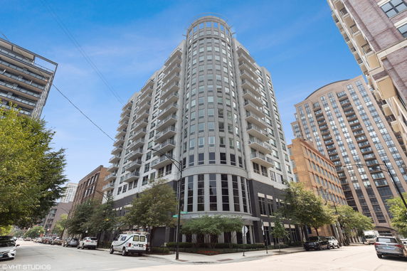 Front view of a multi-story contemporary building with balconies.