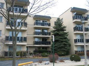 Front view of a multi-story apartment building with balconies.
