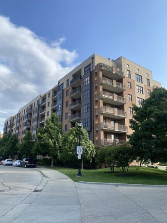 Front view of a multi-story apartment building with balconies.