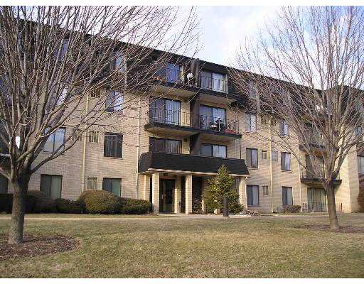 Front view of a multi-story apartment building with balconies.