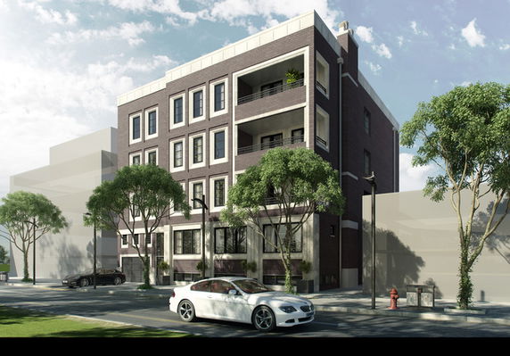 Front view of a multi-story building with balconies and large windows.
