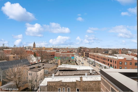 Wide-angle view of a cityscape with buildings and street