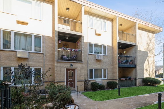 Front view of a multi-story residential building with balconies.