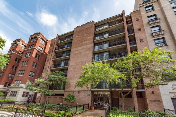 Front view of a multi-story apartment building with balconies.