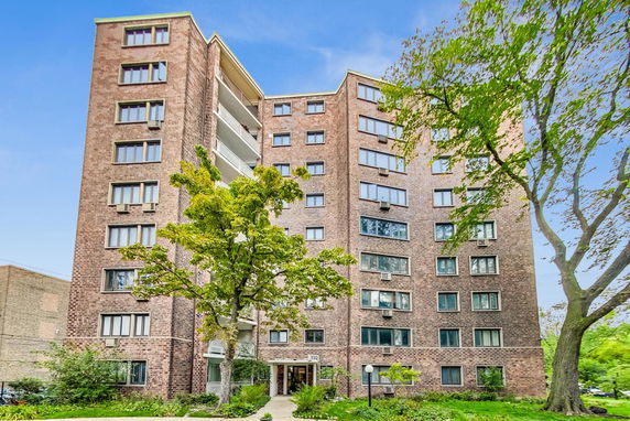 Front view of a multi-story brick apartment building.
