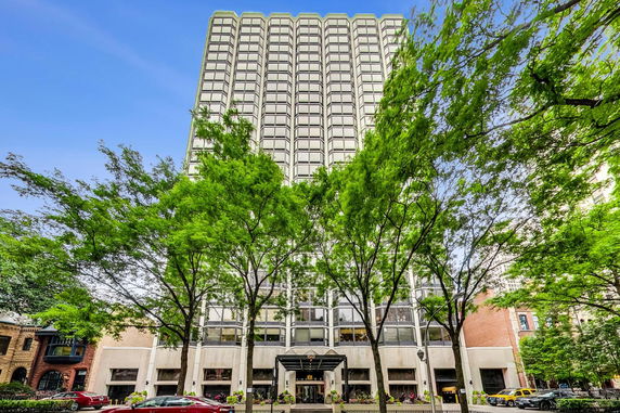 Front view of a tall multi-story building with a canopy at the entrance.