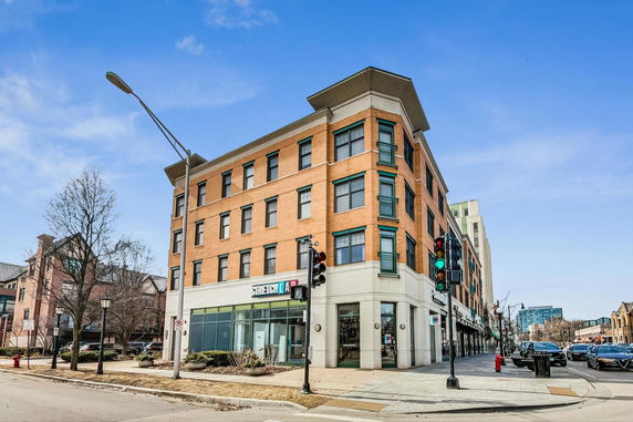 Front view of a multi-story commercial building on a street corner.
