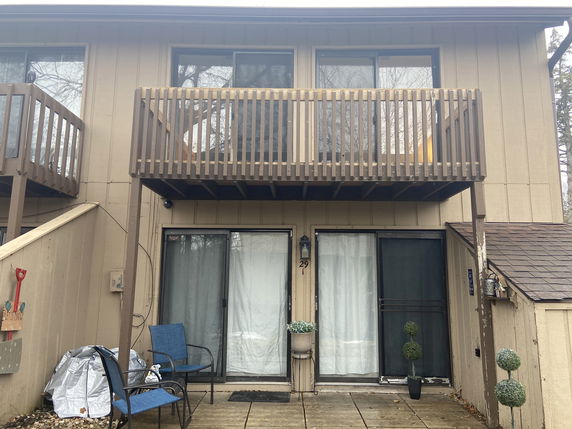 Front view of a two-story house with a balcony.