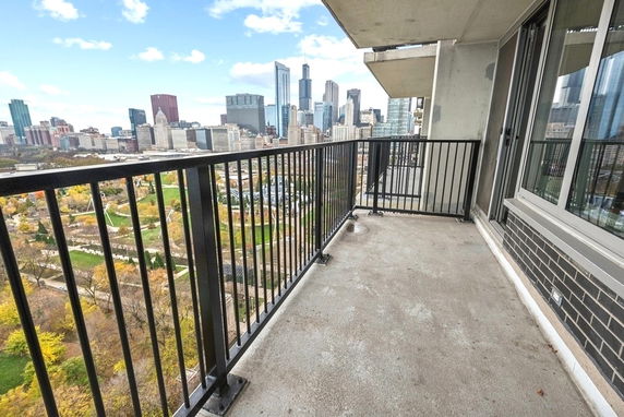 Balcony view of a city skyline with tall buildings.