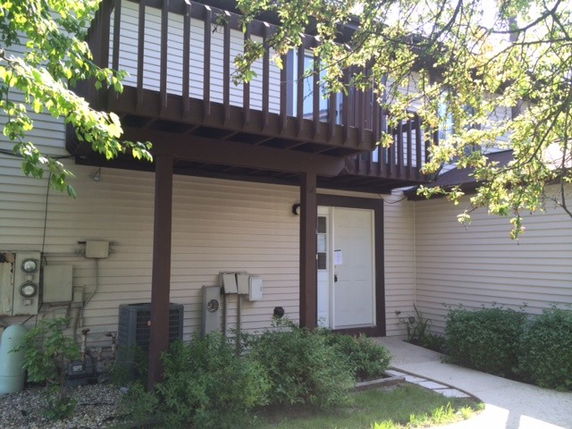 Front view of a two-story house with a balcony.