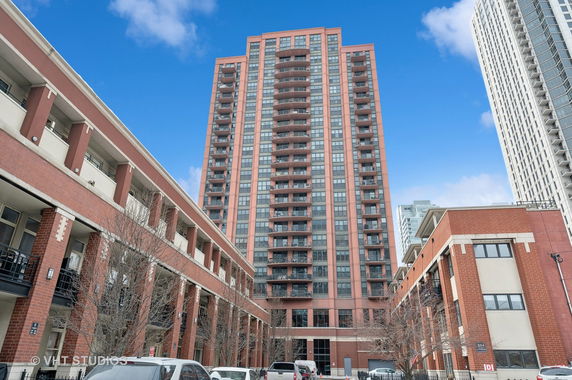 Front view of a tall residential building with balconies.