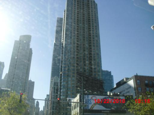Front view of a tall multi-story building in an urban setting.