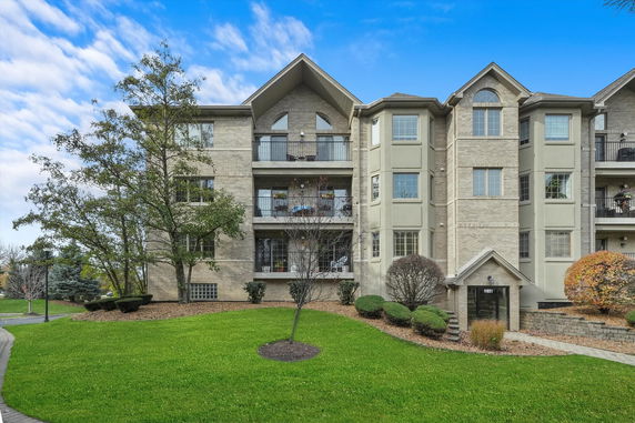 Front view of a multi-story residential building with balconies.