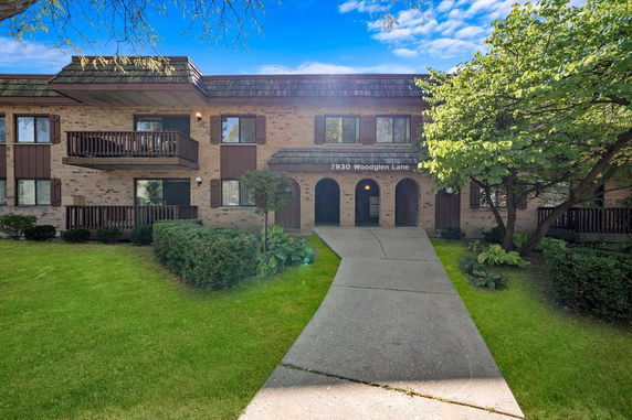 Front view of a two-story residential building with balconies.