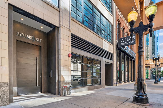Front view of a multi-story building with a modern entrance labeled 223 Lake Loft.