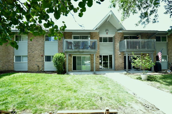 Front view of a two-story apartment building with balconies.