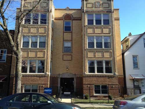 Front view of a multi-story brick residential building.