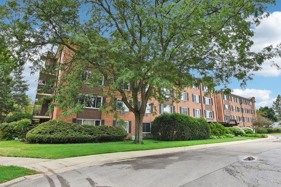 Front view of a multi-story brick apartment building.