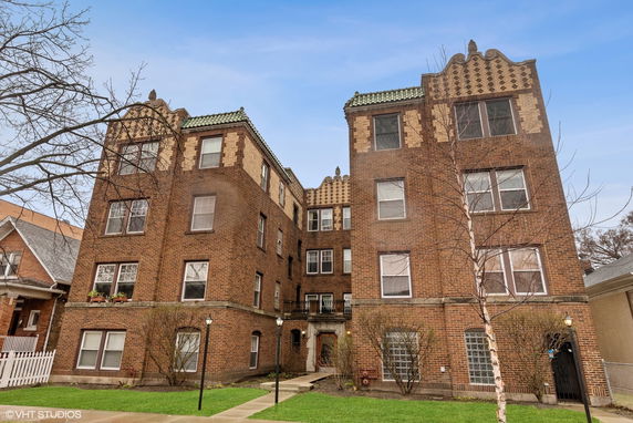 Front view of a multi-story brick apartment building.