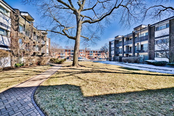 Front view of an apartment complex with multiple stories and balconies.