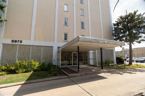 Front view of a multi-story building with an entrance canopy.