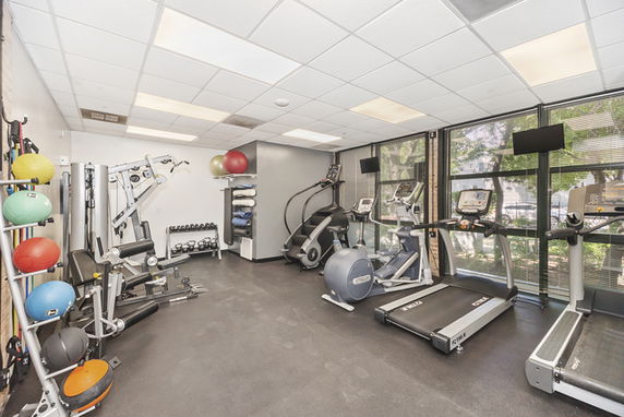 Room equipped with exercise machines and gym equipment.