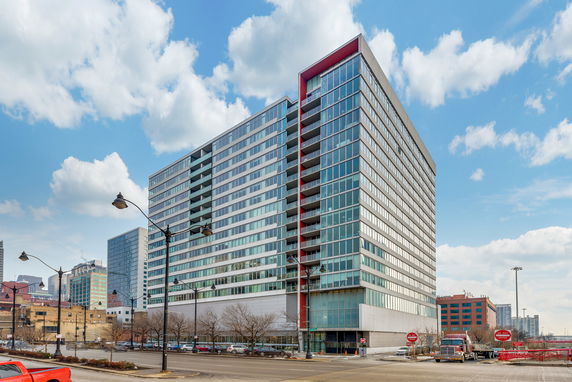 Front view of a multi-story modern office building with glass windows.