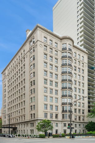 Front view of a multistory building with a classic architectural style.