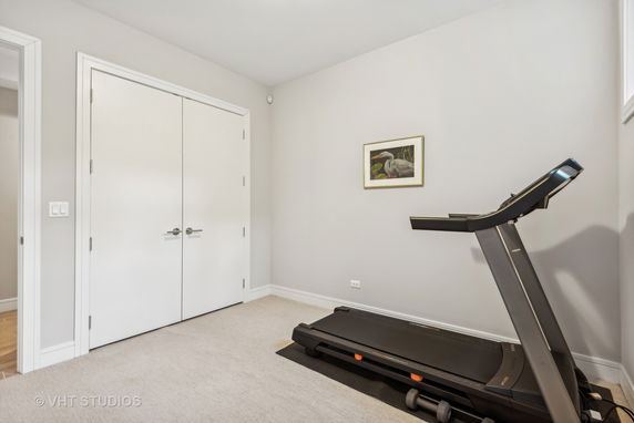 Room with a treadmill and double doors