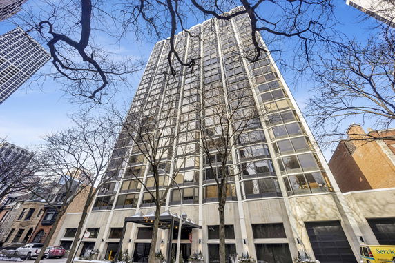 Front view of a tall residential building with multiple windows.