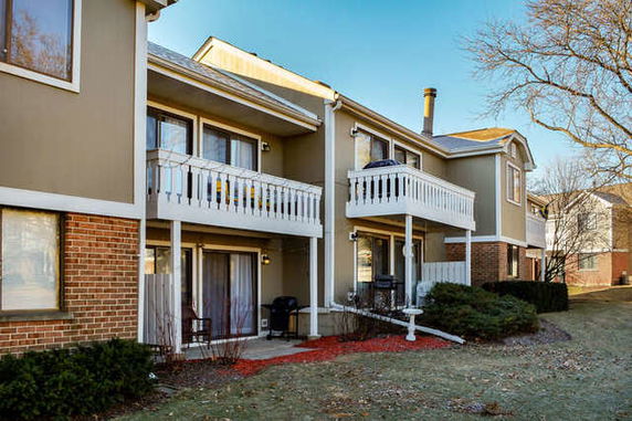 Front view of a two-story residential building with balconies