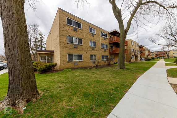 Front view of a multi-story brick apartment building.