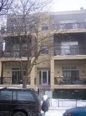 Front view of a multi-story residential building with balconies.