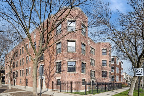 Front view of a multi-story brick apartment building.