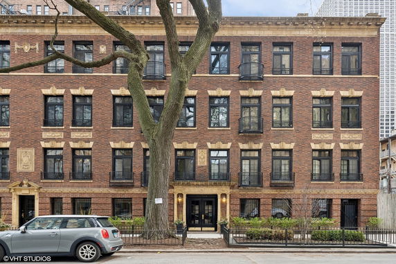 Front view of a multi-story brick building with decorative window accents.